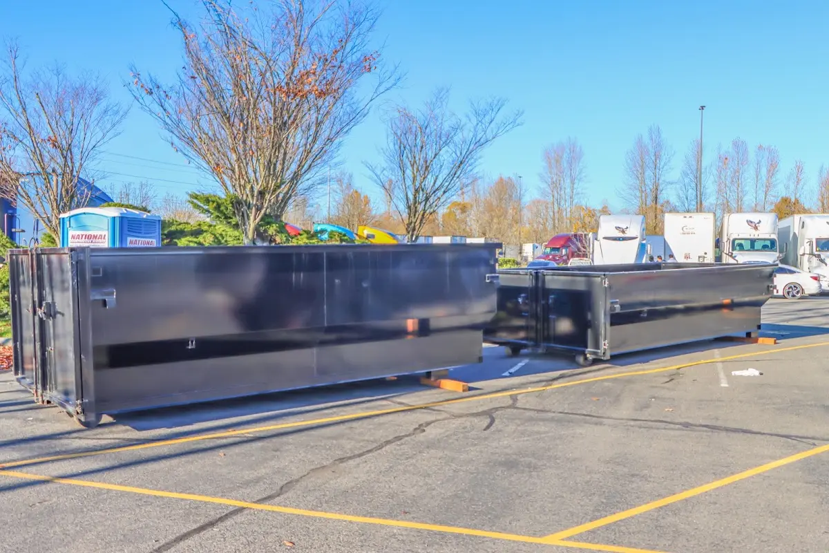 Professional dumpster rental service with roll-off container on residential driveway in Delhi Hills